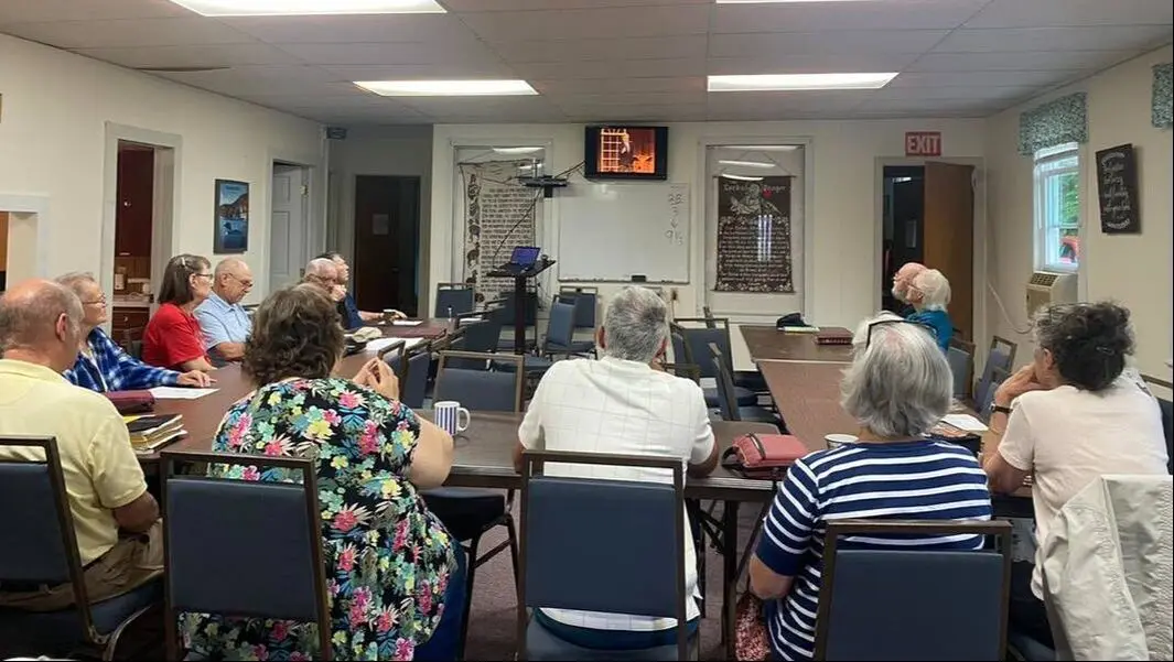The church family gathered around tables in the fellowship hall