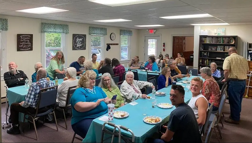 The church family sharing a meal together in the fellowship hall