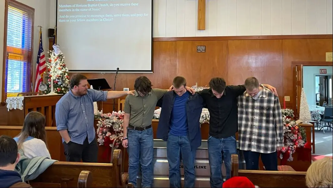 Members gathered at the front of the church praying together